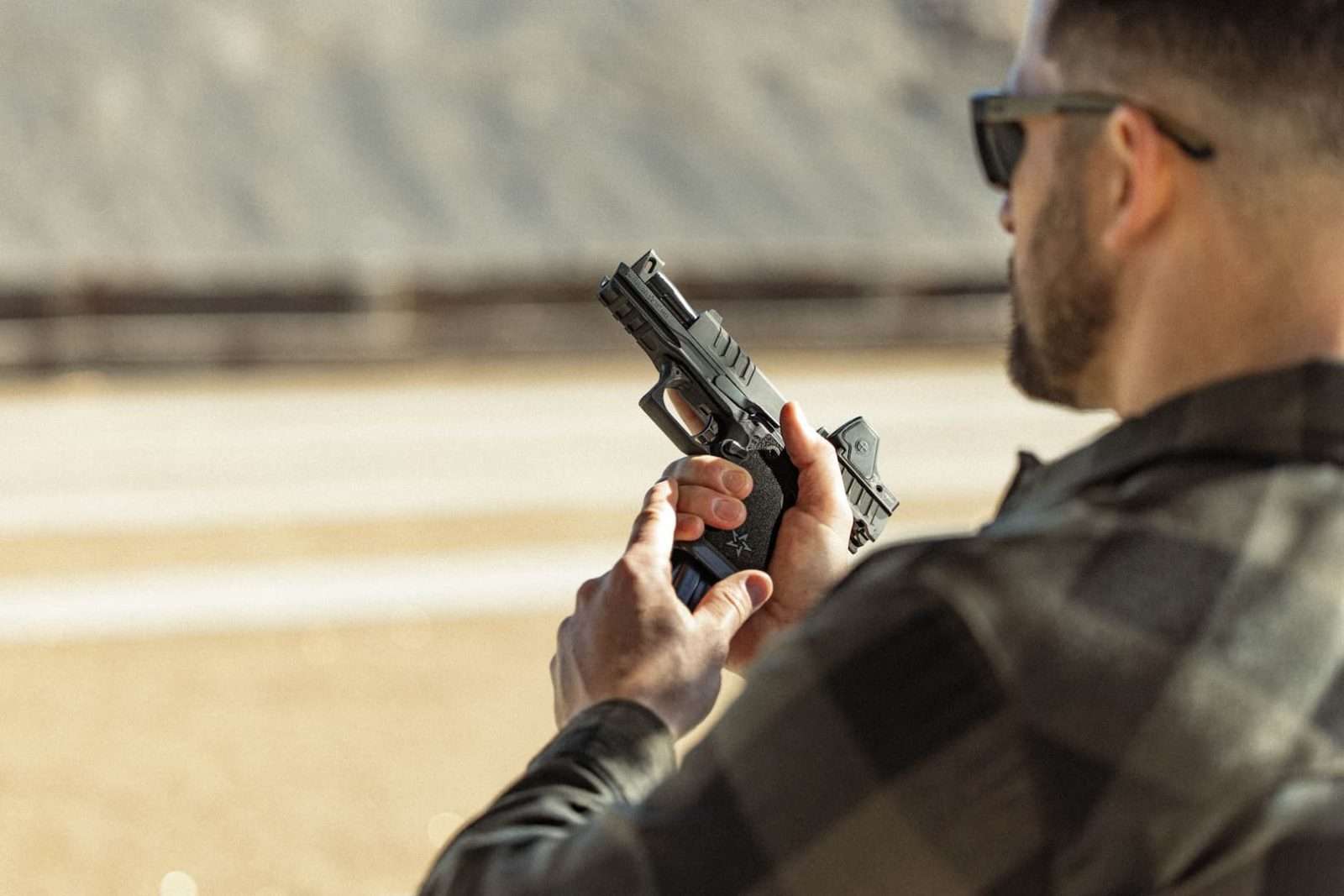 Shooter inspecting a Staccato at the range